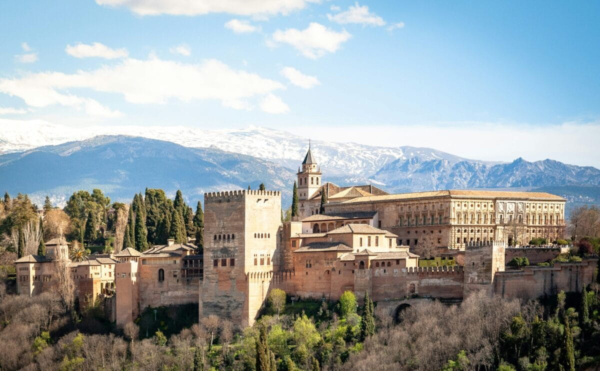Scenic view of Andalusia featuring white villages, historic landmarks, mountains, and Mediterranean coastline in southern Spain