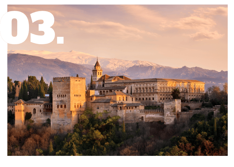 Alhambra Palace in Granada at sunset with snow-capped Sierra Nevada mountains - Andalucia Tours Alhambra private tours and skip the line tickets