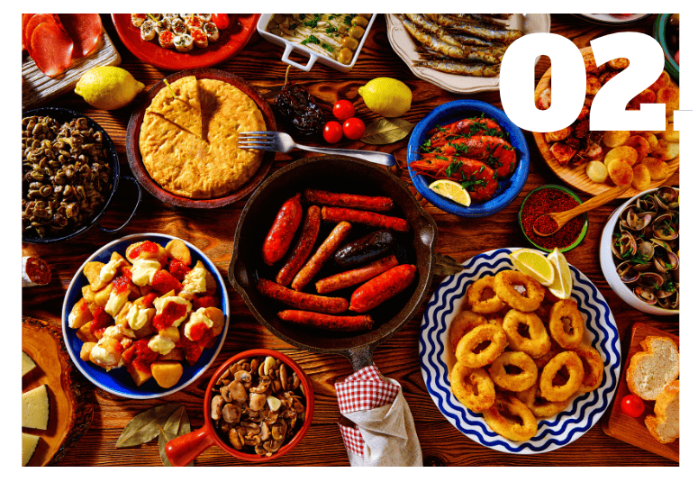 Authentic Andalusian tapas spread with tortilla, chorizo, calamares, jamon and olives - Andalucia Tours Seville tapas food tour, Andalusian food