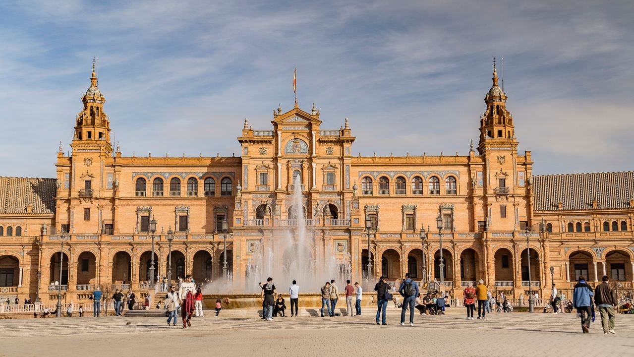 Central fountain at Plaza de España surrounded by historic architecture in Seville