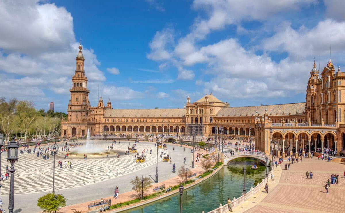 Plaza de España Seville canal with bridge, boats and fountain in María Luisa Park 2026