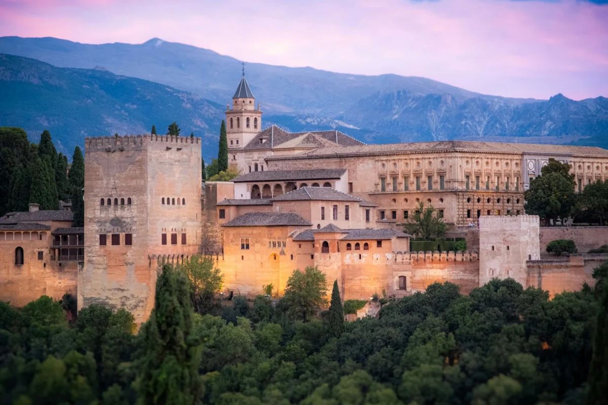Visit the Alhambra Palace in Granada Visitors exploring the historic Alhambra Palace in Granada, Andalusia, Spain