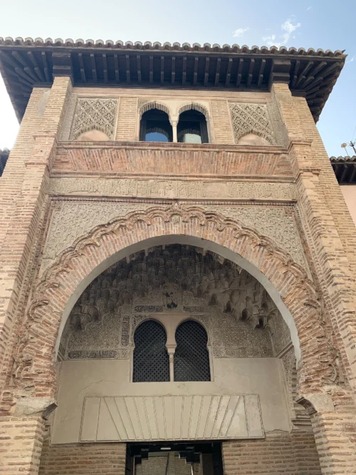 Corral del Carbón Façade in Granada Ornate Nasrid horseshoe arch at the entrance of Corral del Carbón in Granada, Spain