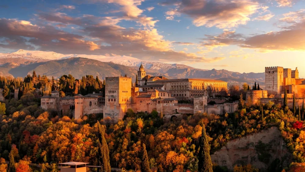 Sunset at Mirador de San Nicolás, Granada Sunset over the Alhambra and Sierra Nevada mountains from Mirador de San Nicolás in Granada, Spain.