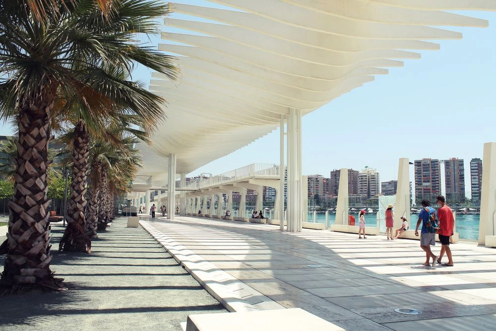 Muelle Uno Waterfront in Málaga, Spain Muelle Uno waterfront promenade with boats and restaurants in Málaga, Spain