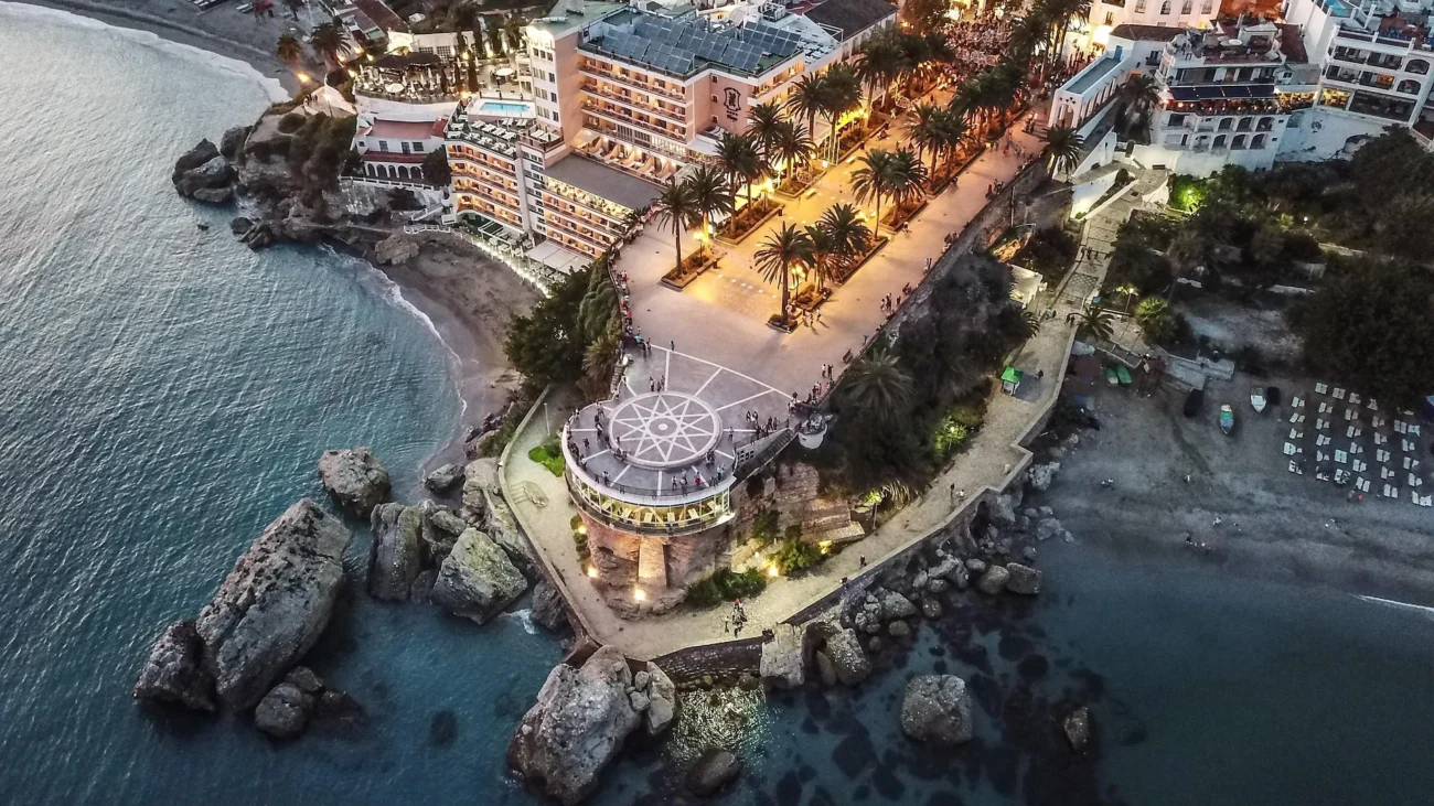 Nerja, Spain – Costa del Sol Picturesque coastal town of Nerja with white buildings, turquoise Mediterranean Sea and surrounding mountains
